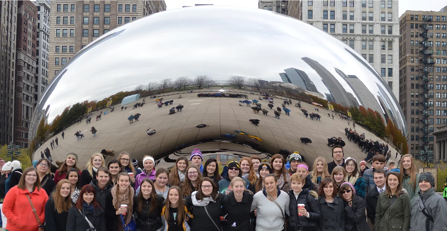 students taking photo with teacher