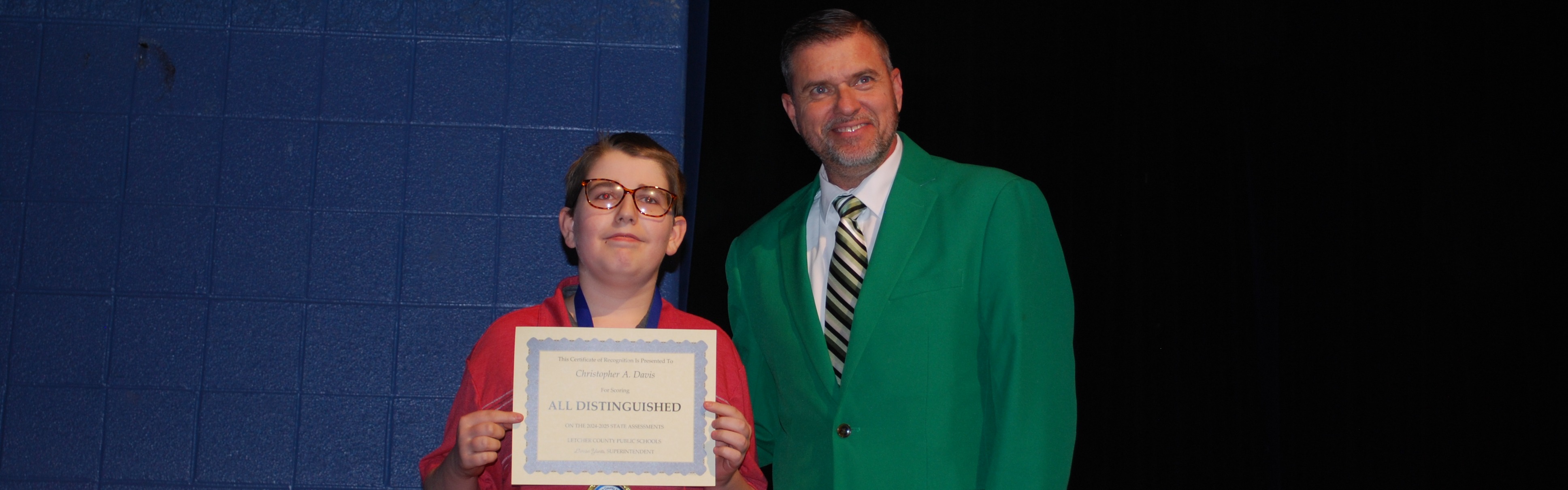 Picture of Principal and Student receving award.
