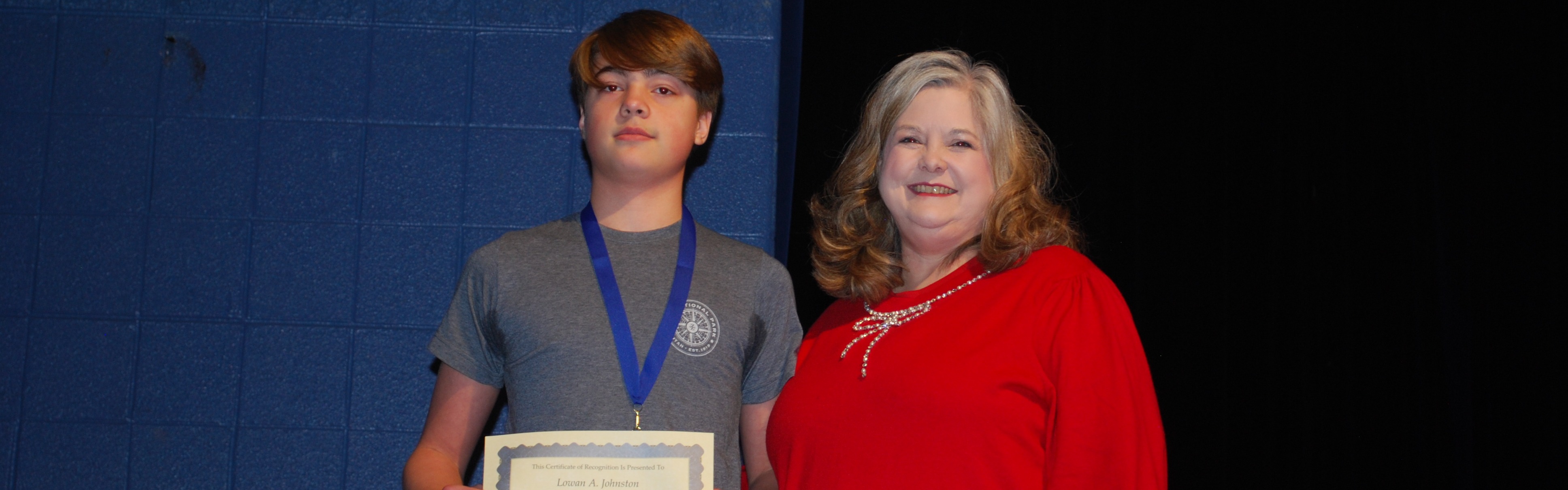 Picture of Principal and Student receving award.