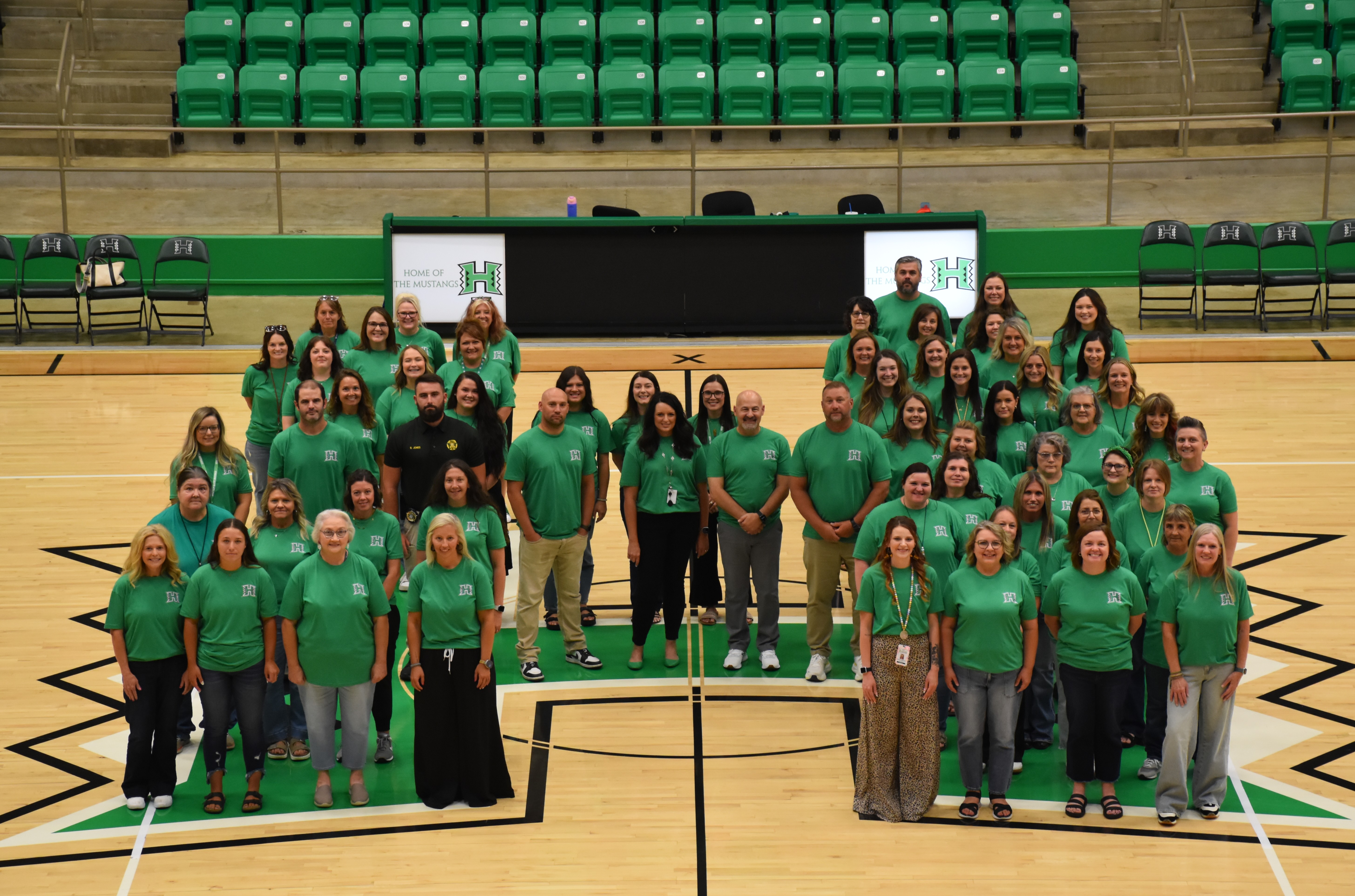 Hoxie Public School's elementary staff stand in the shape of a H.