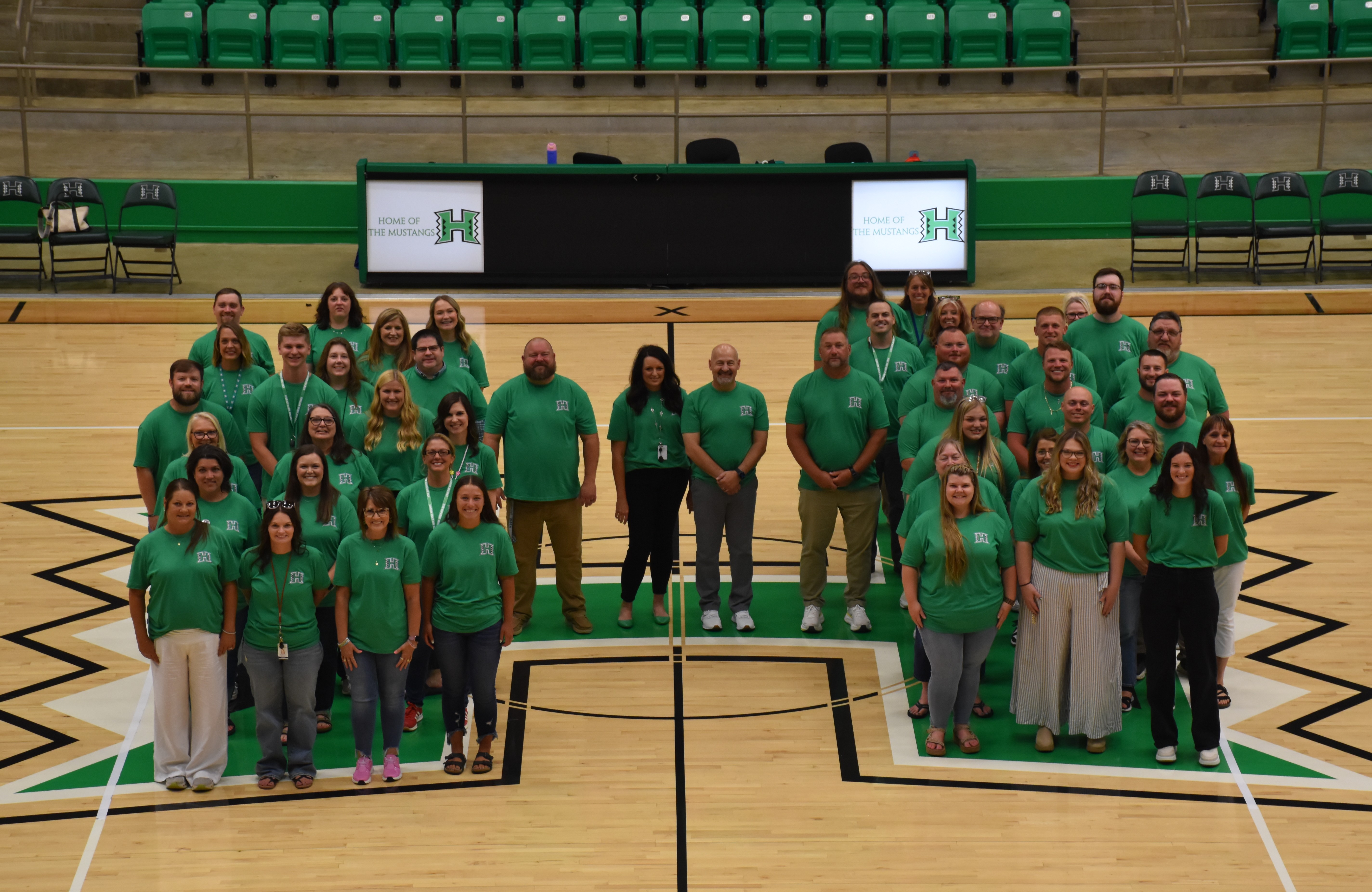 Hoxie Public School's highschool staff stand in the shape of a H.
