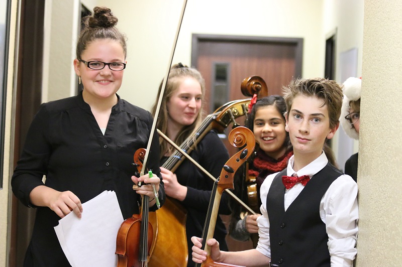 Students posing with violins