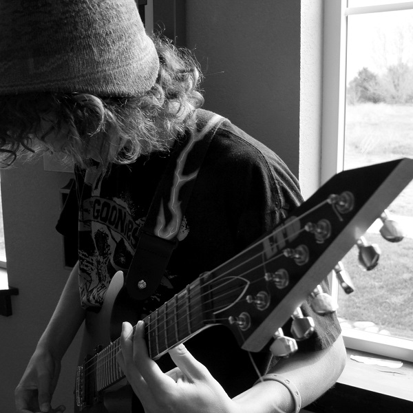 Student playing an electric guitar