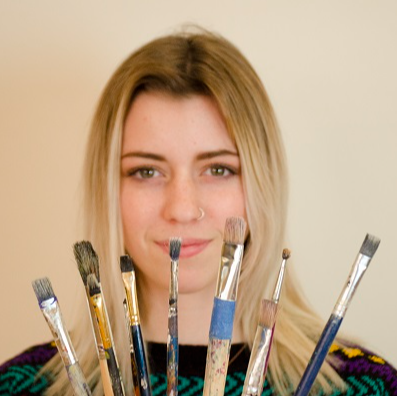 Student showing her paintbrushes