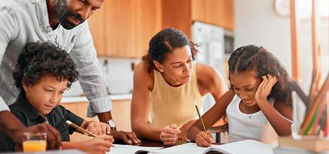 A photo of the family doing home schooling.