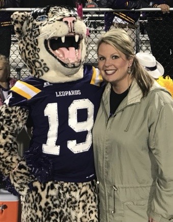 A photo of BECKY LITTLE with the school mascot.