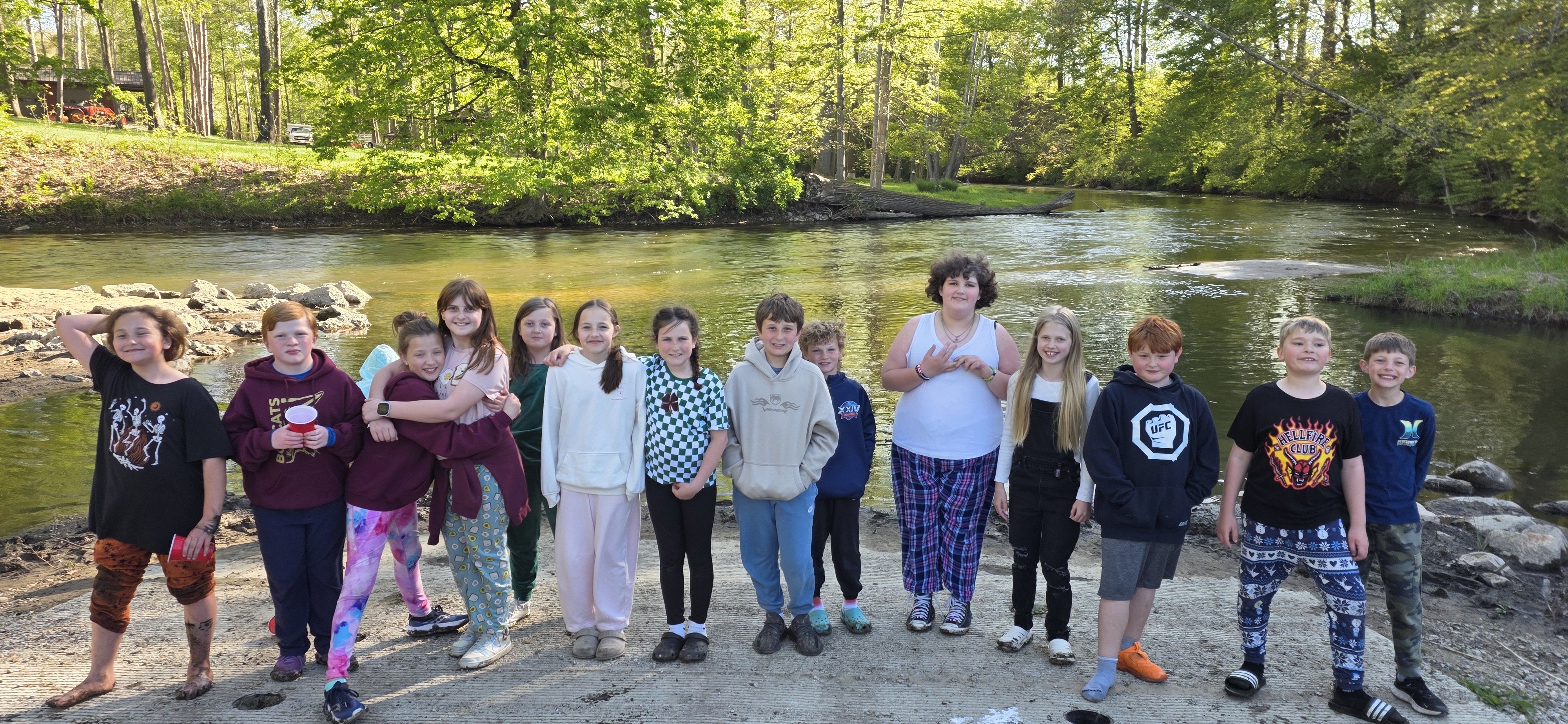 group of kids standing in front of the river