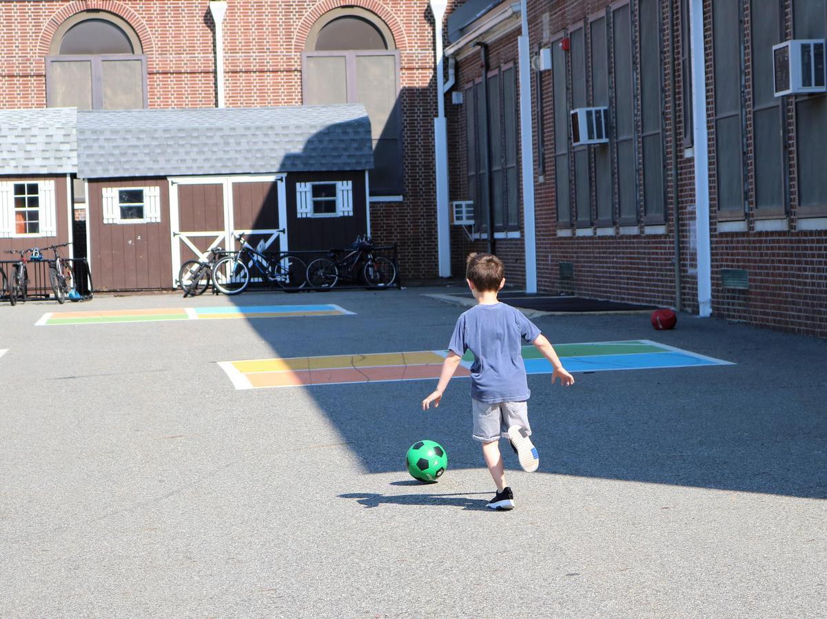 Child running with ball