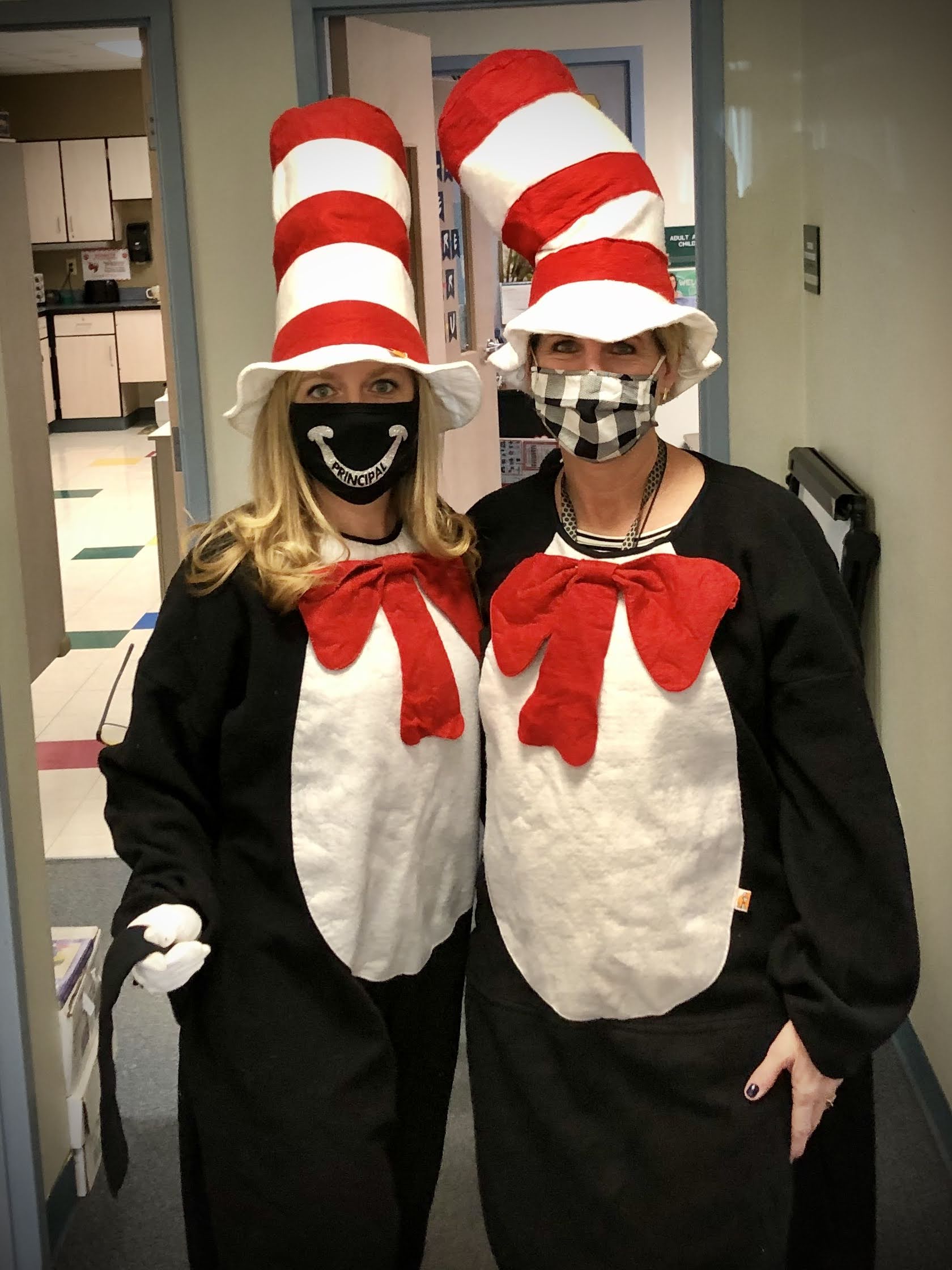 Two teachers dressed as the Cat in the Hat character