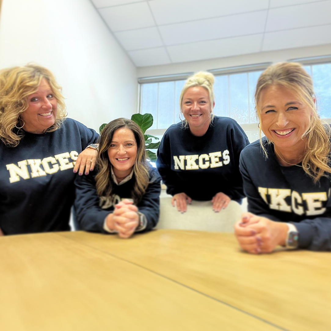 Ladies smiling in matching shirts