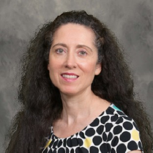 dark haired woman with polka dot shirt