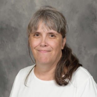 dark haired woman wearing white shirt