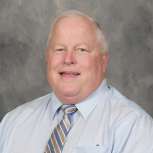 gray haired man wearing shirt and tie