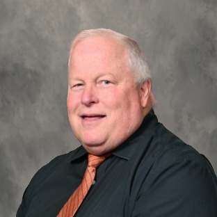 gray haired man wearing shirt and tie