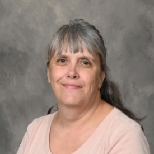 dark haired woman wearing pink shirt