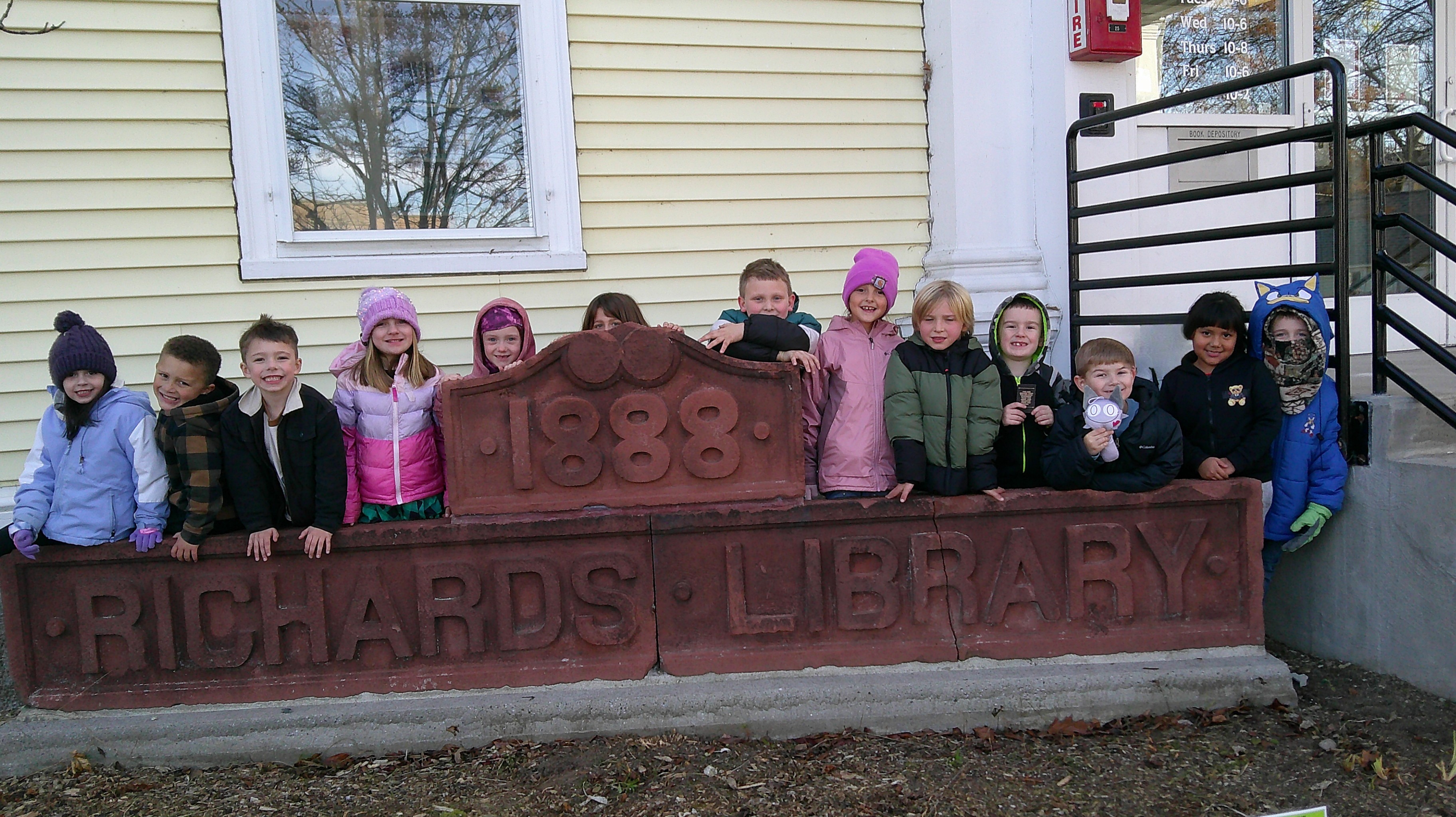 children standing outside town library 