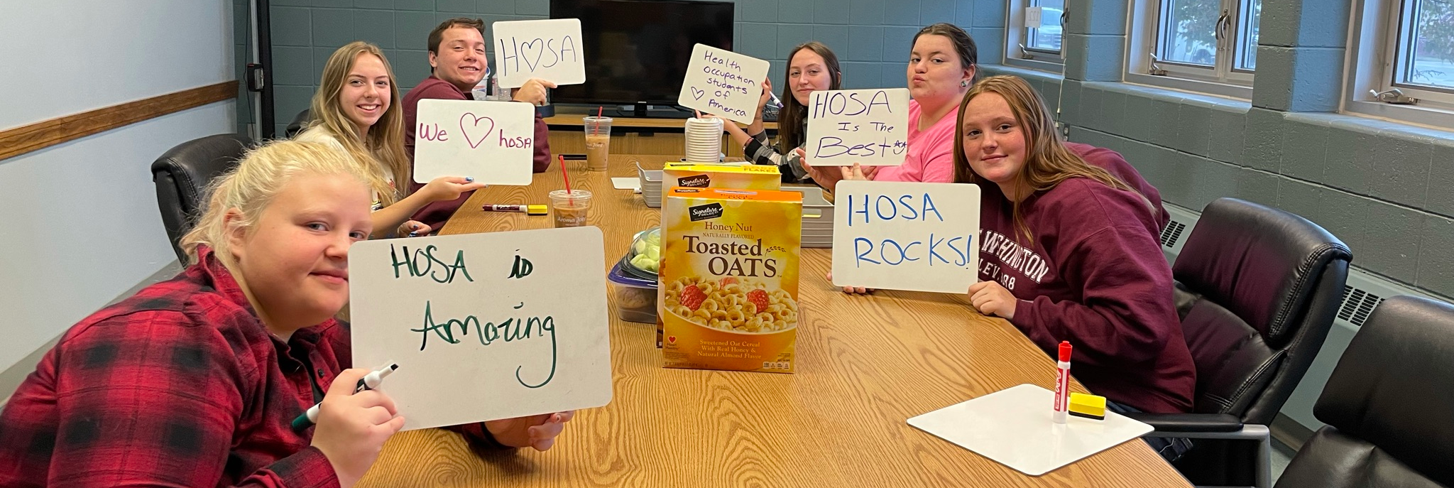 Health students  hold signs praising HOSA