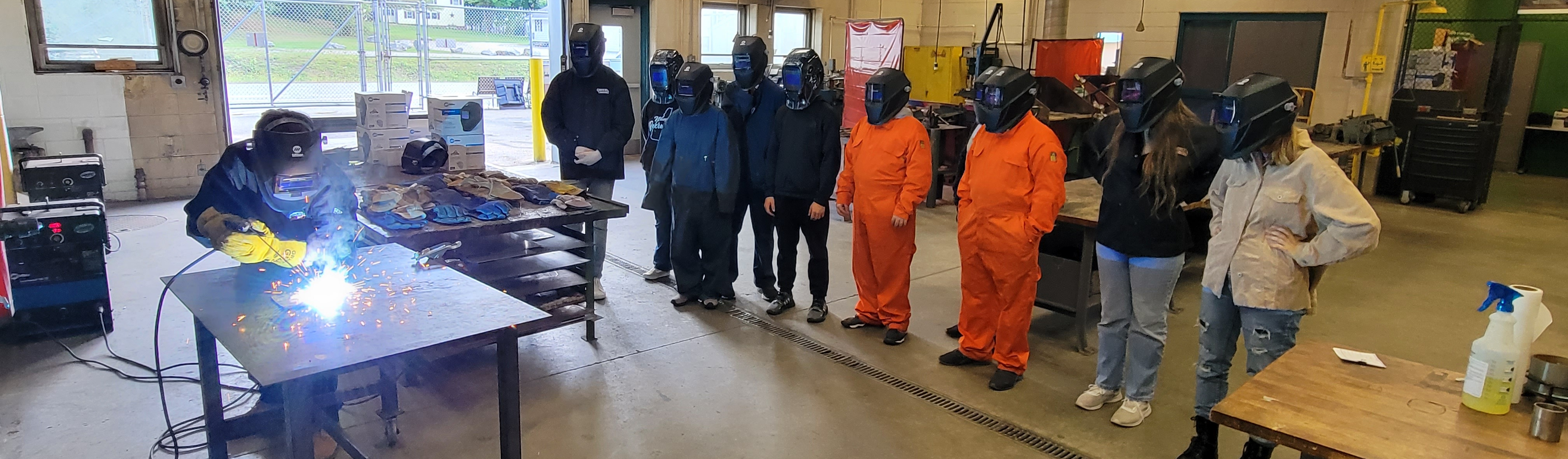 Students learning to weld in the shop