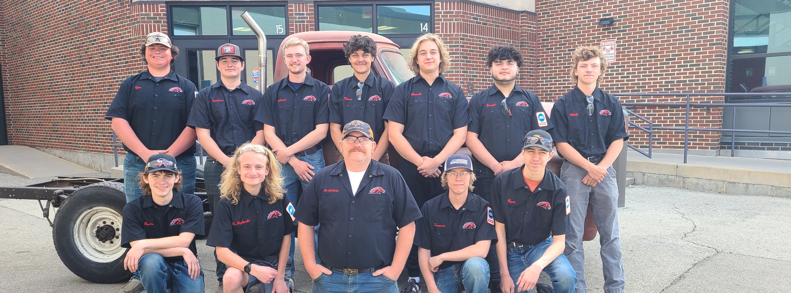 Automotive students wearing new shop shirts