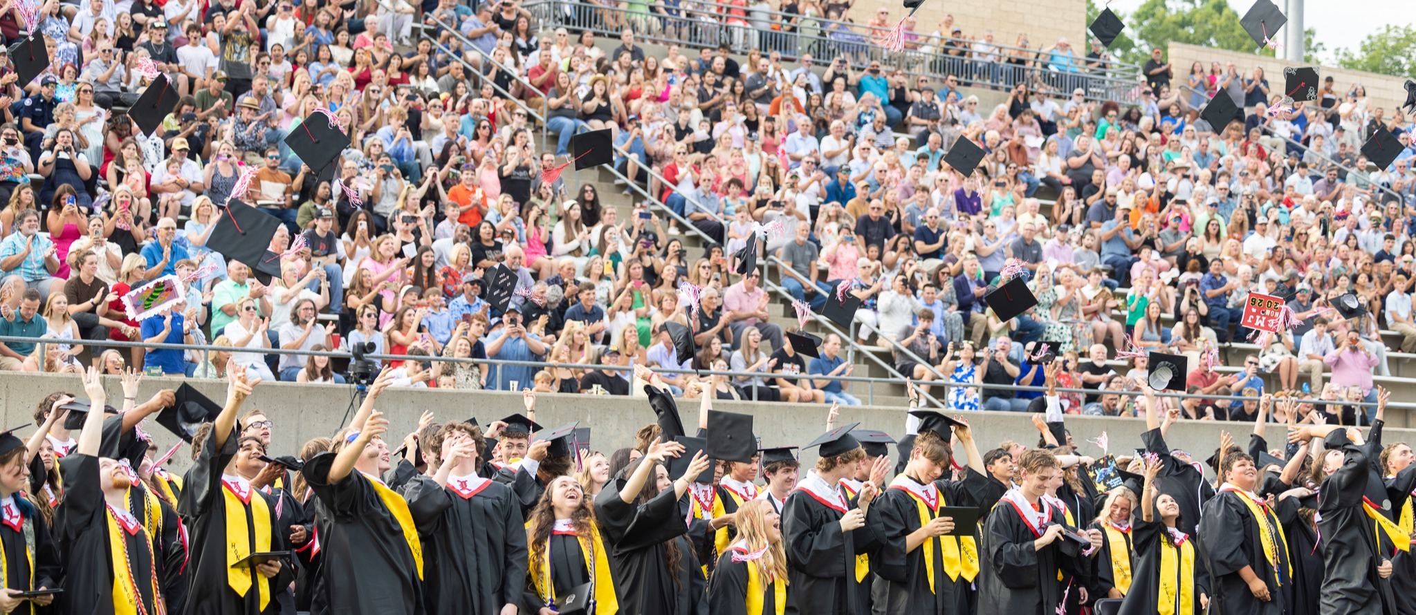landrum graduates throwing their cap in the air