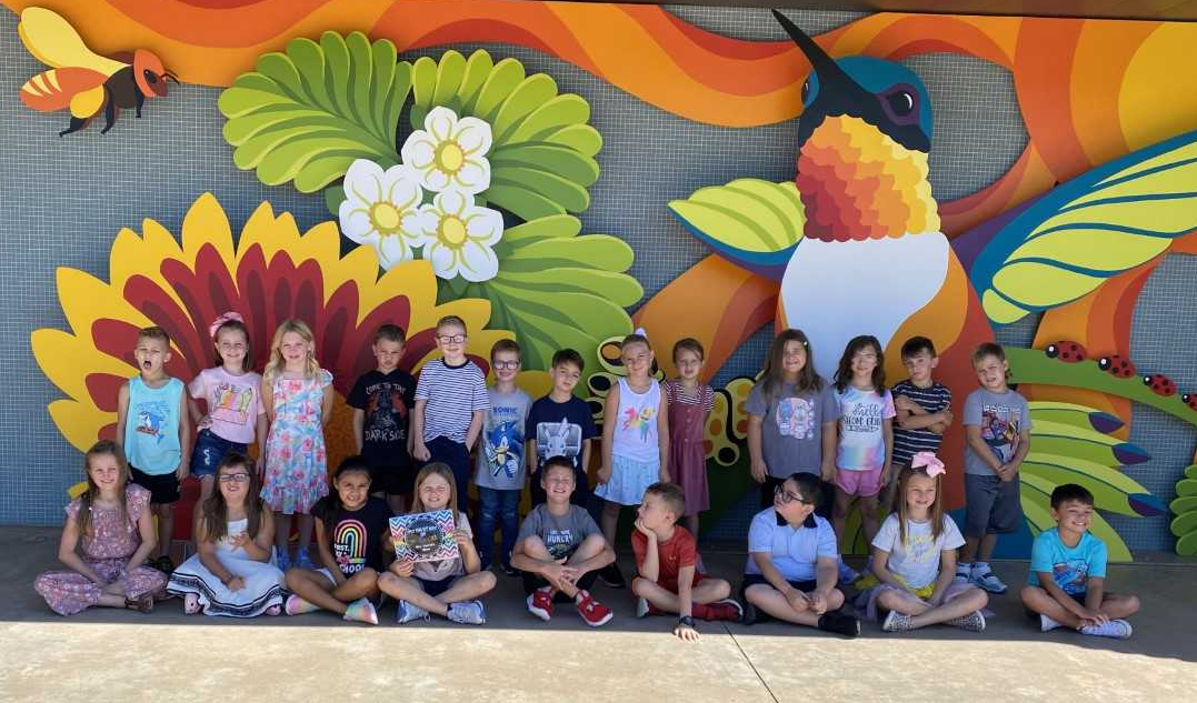 Class in front of mural