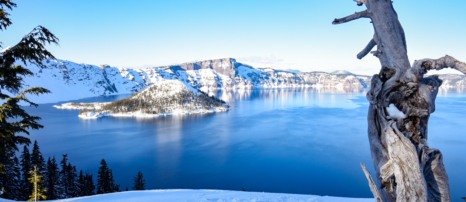 overhead view of crater lake with snow