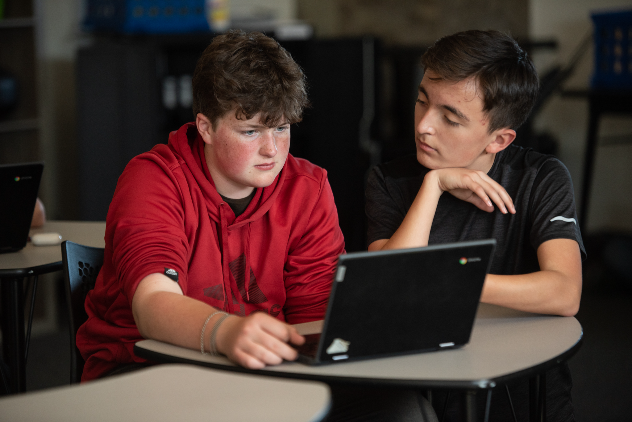 two males students looking at a computer