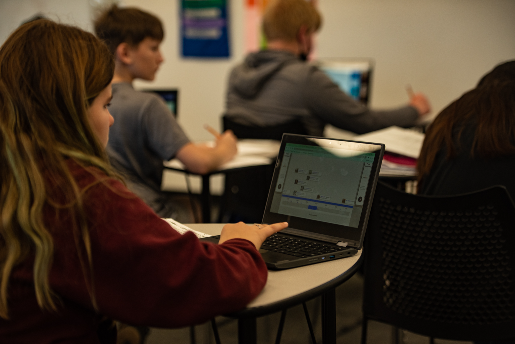 student sitting at desk looking at computer