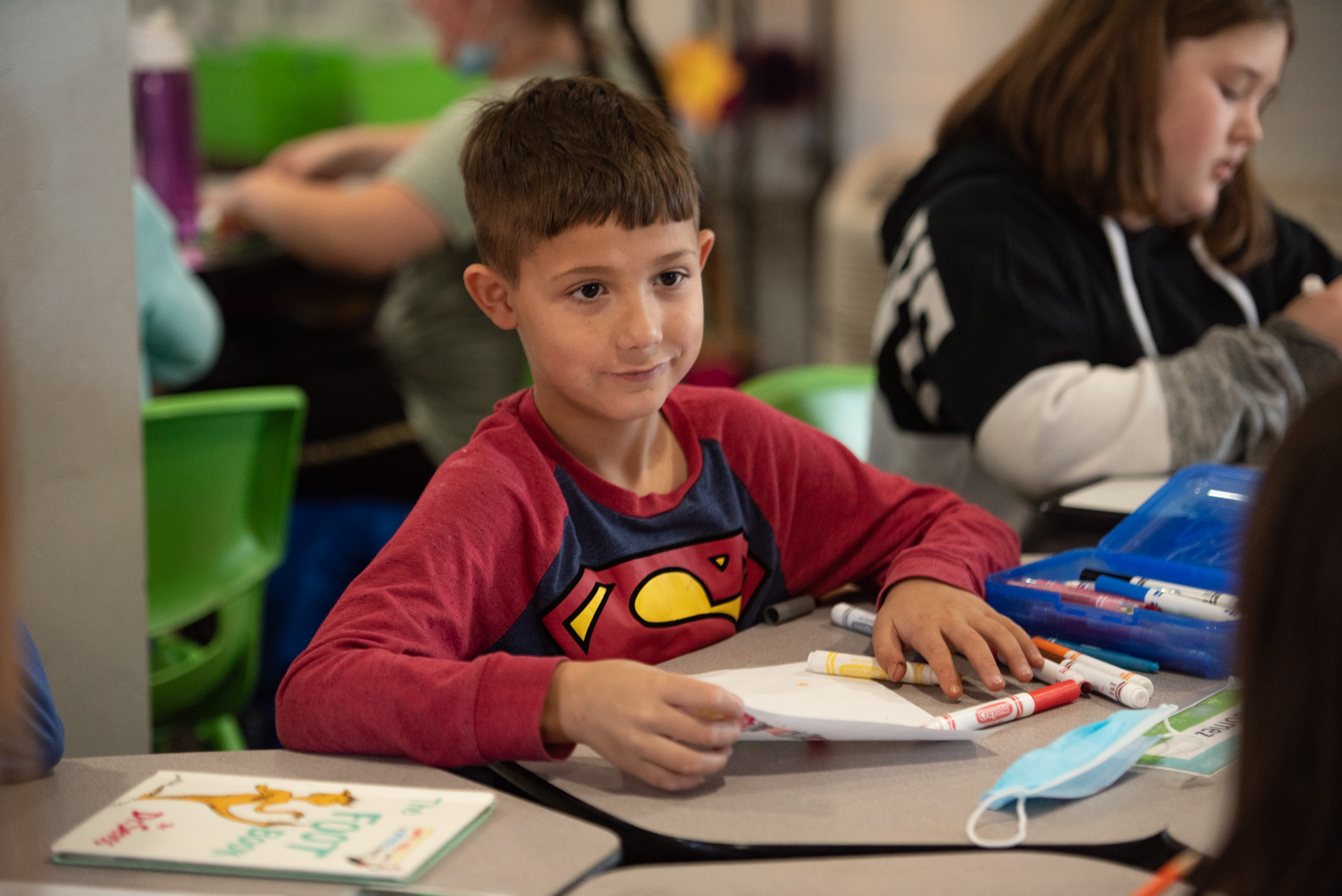 student at desk with markers