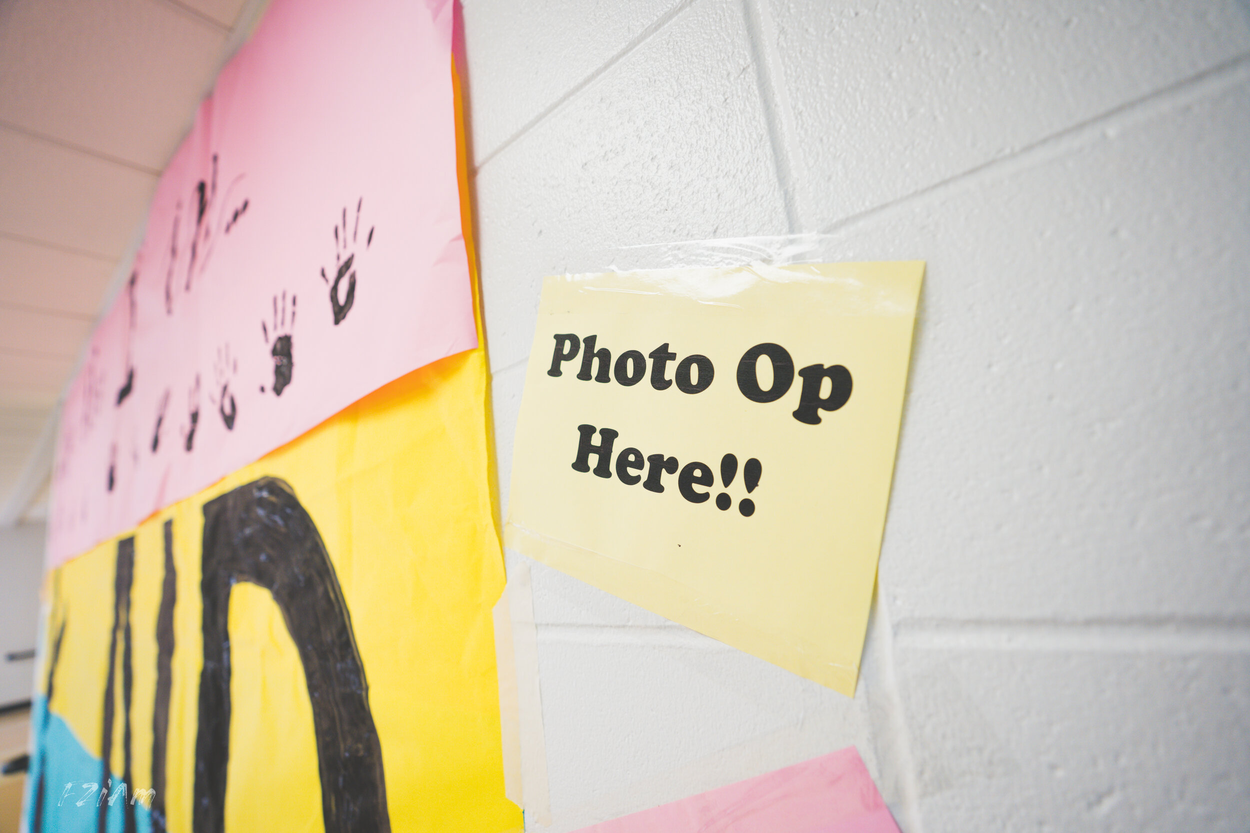 students creating and posing with kind sign