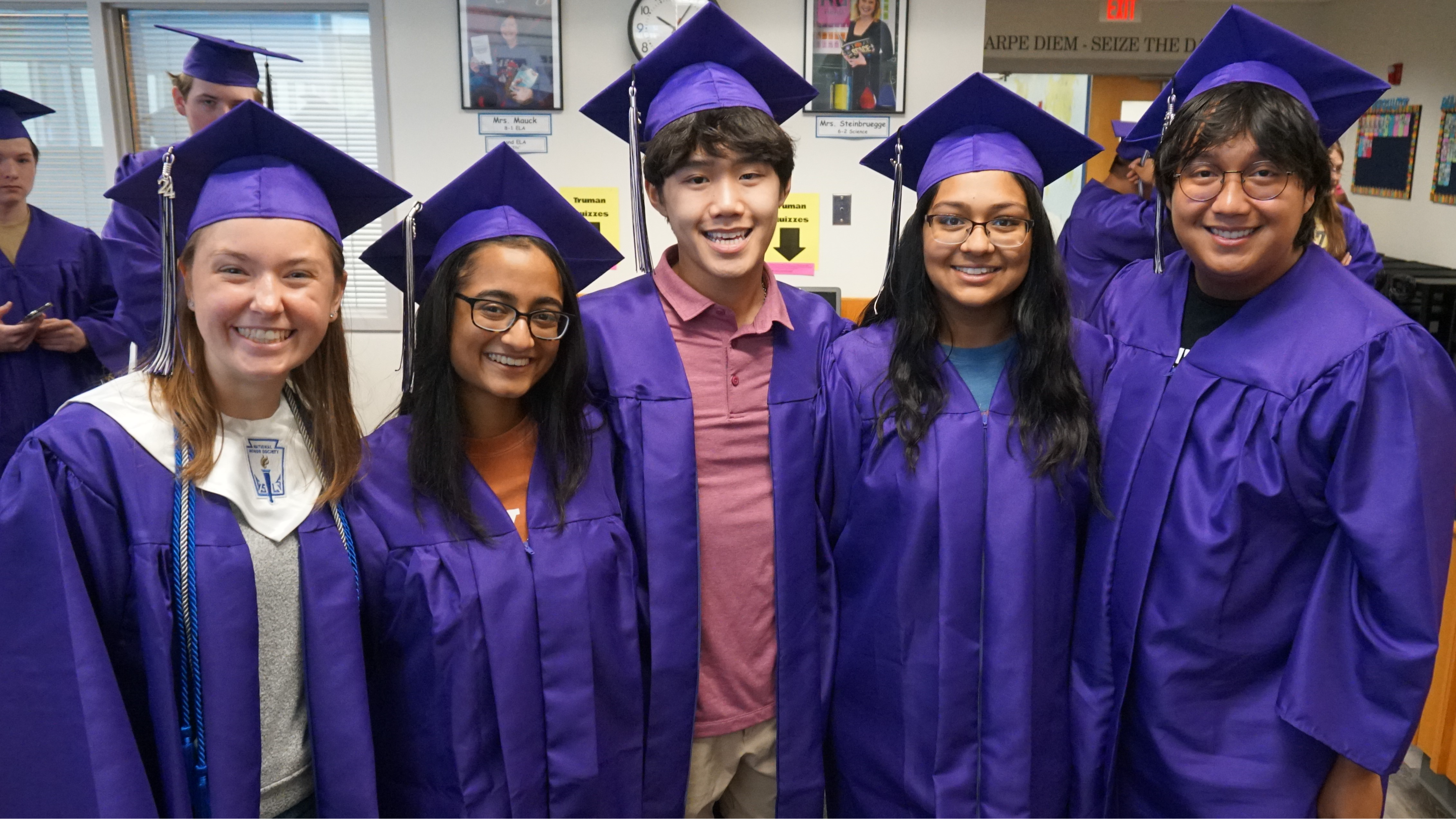 Seniors in cap and gown visit middle schools for a clap out