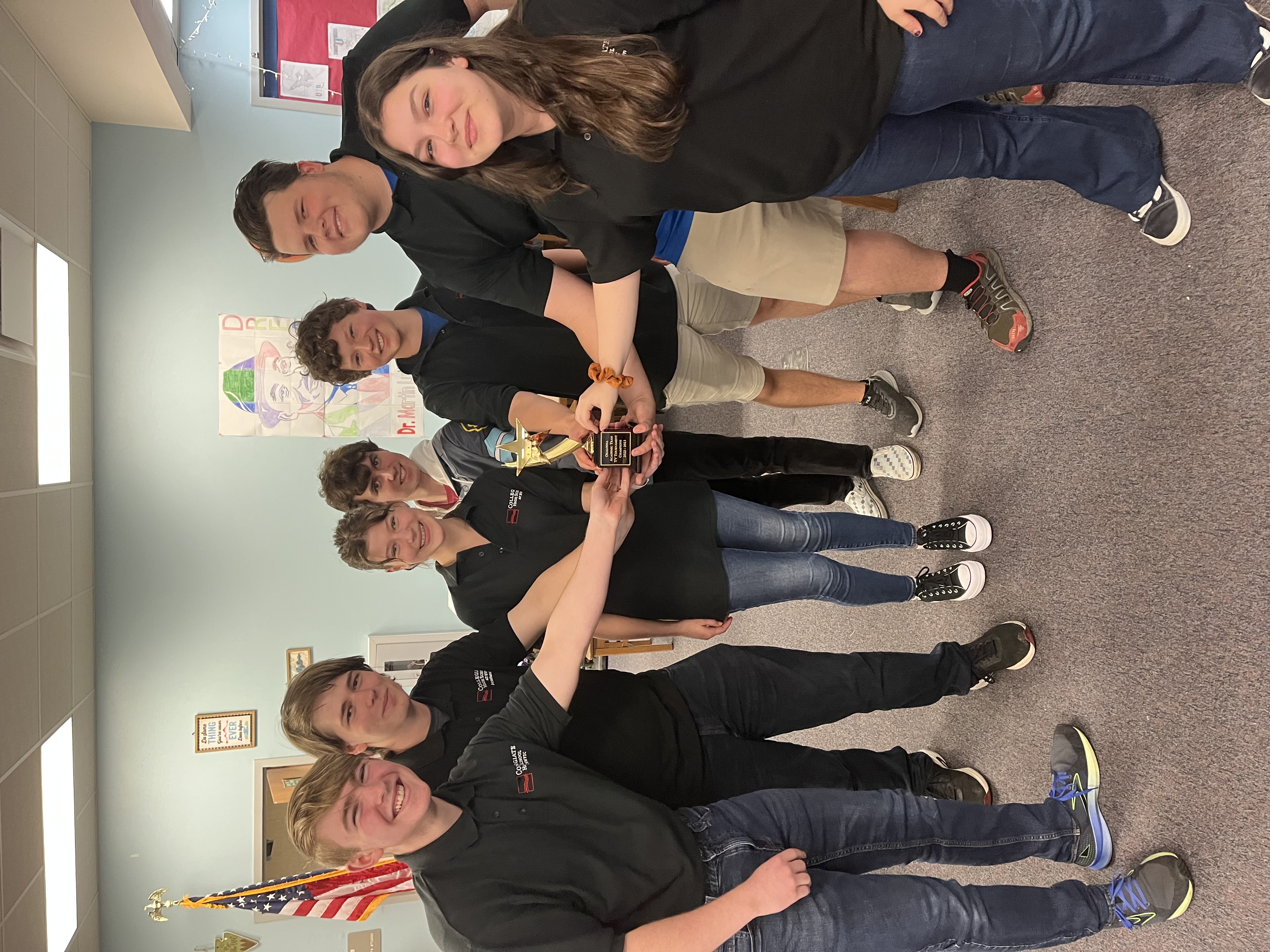 Students holding trophy