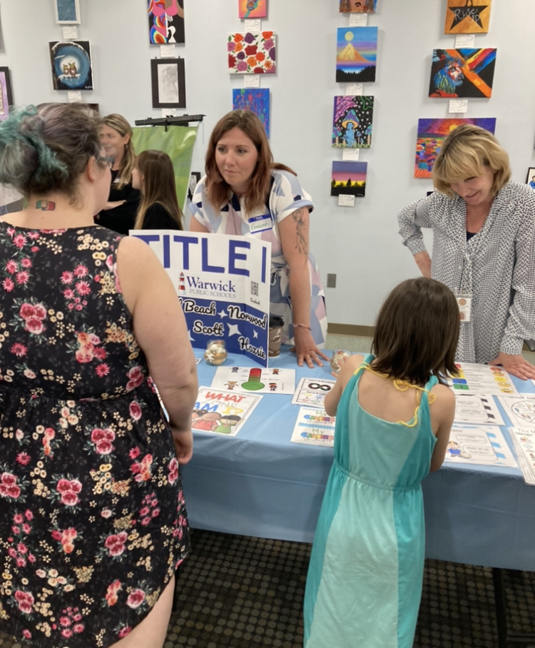 Mrs. Kadek and Mrs. Thornton engaging with mother and child