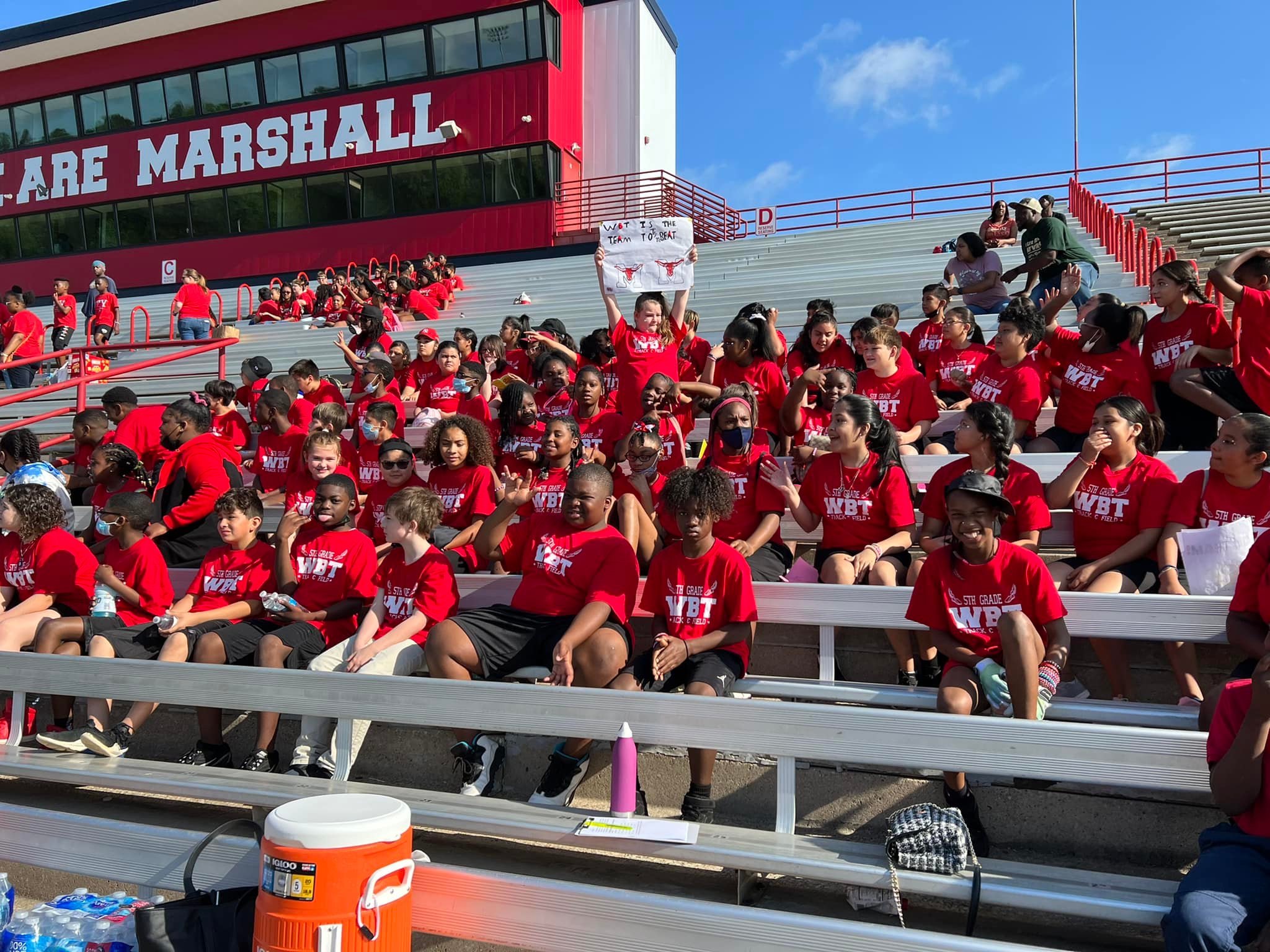 Students cheering in the stands at field day