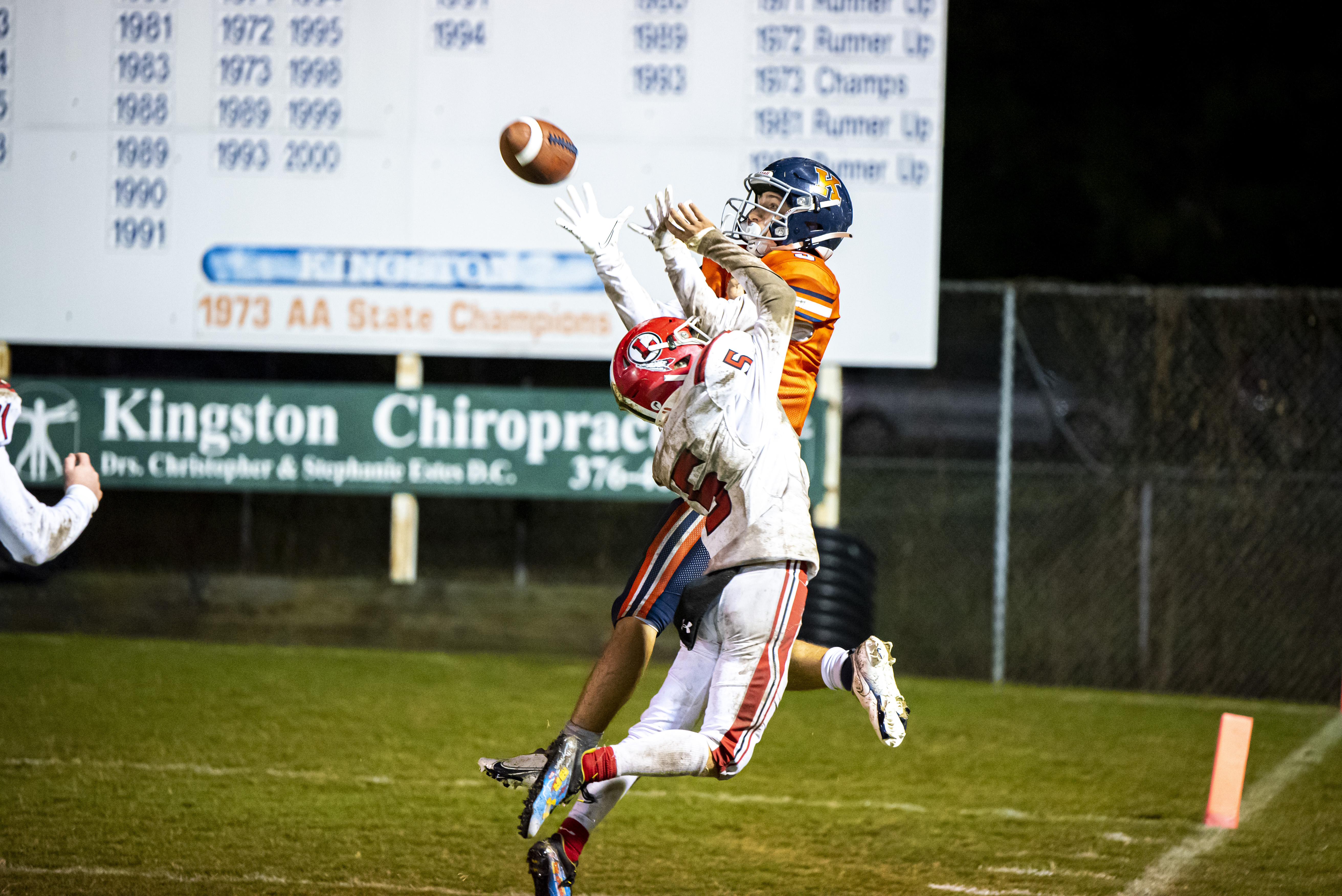 Football players catches ball in endzone