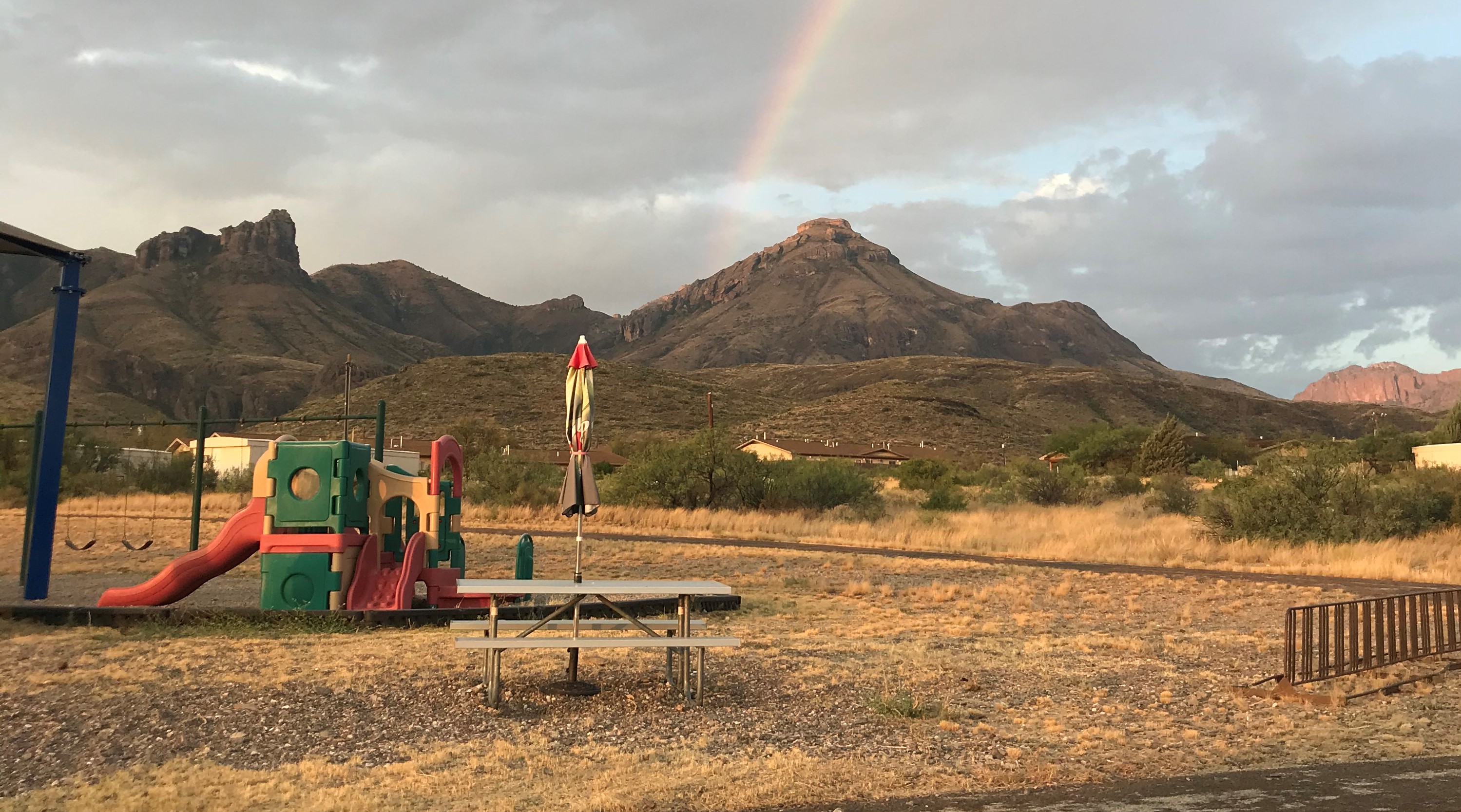 Playground with a rainbow in the background