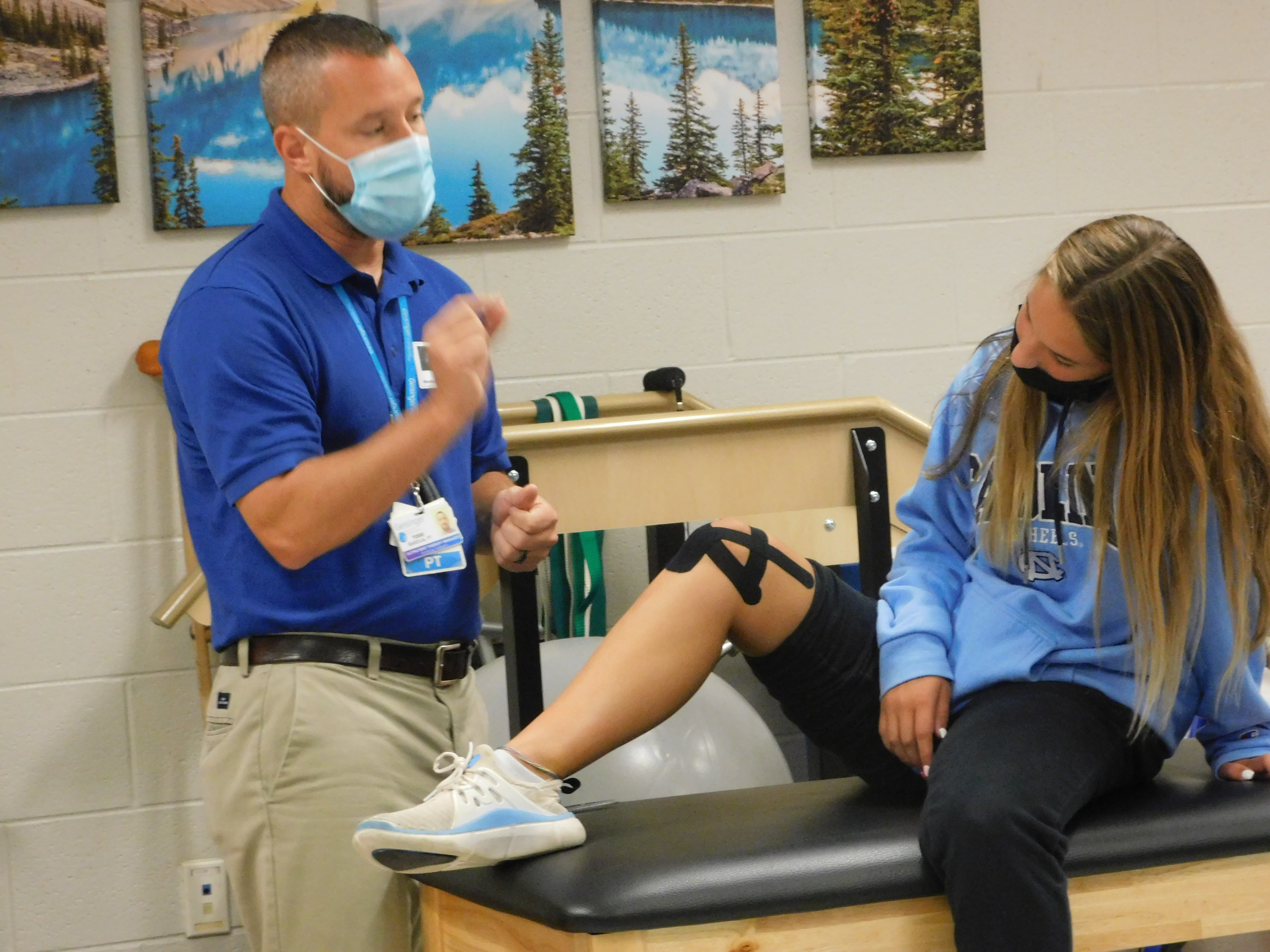 Image of a Physical Therapist working with a student