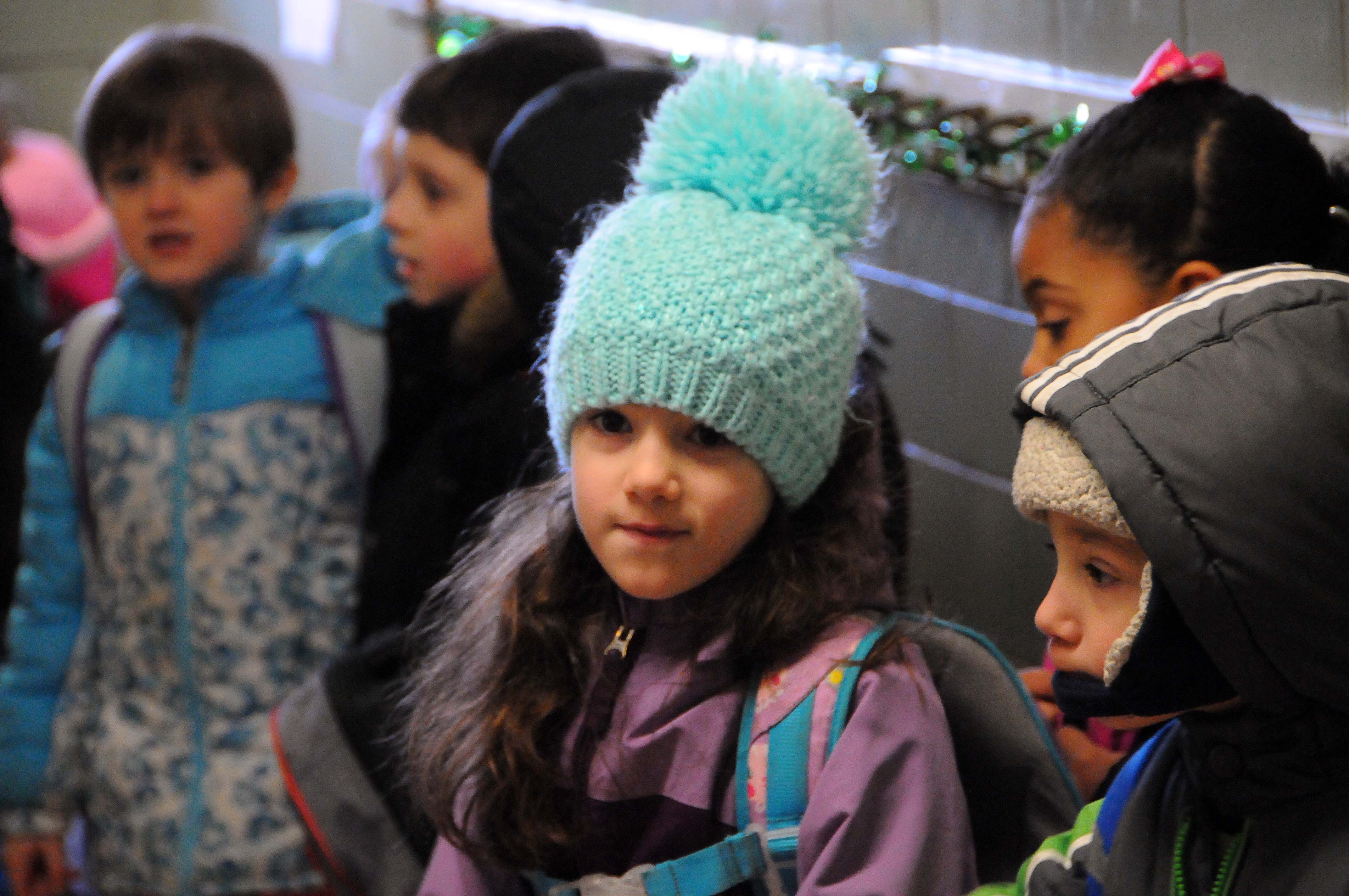 Girl wearing a winter hat at school