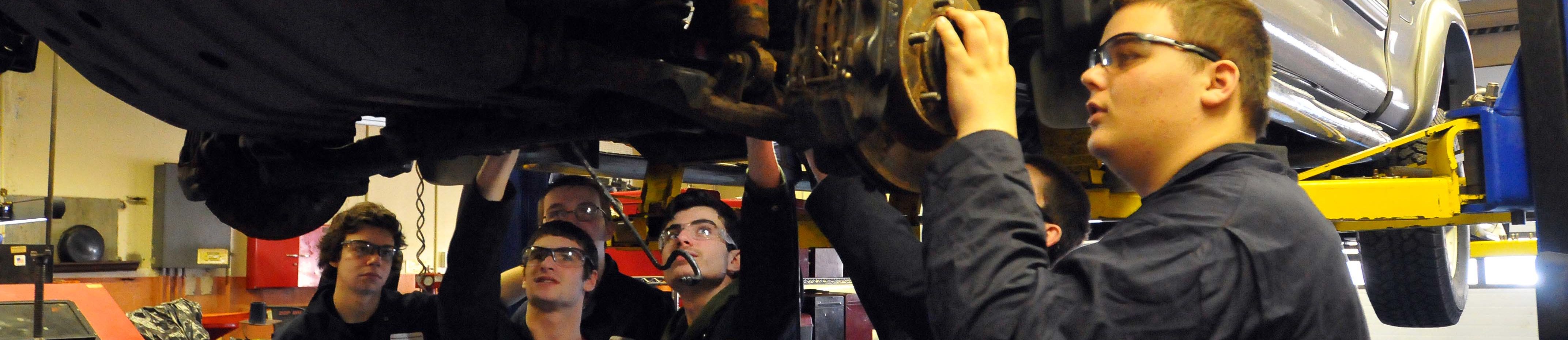 Teens workiing as mechanics