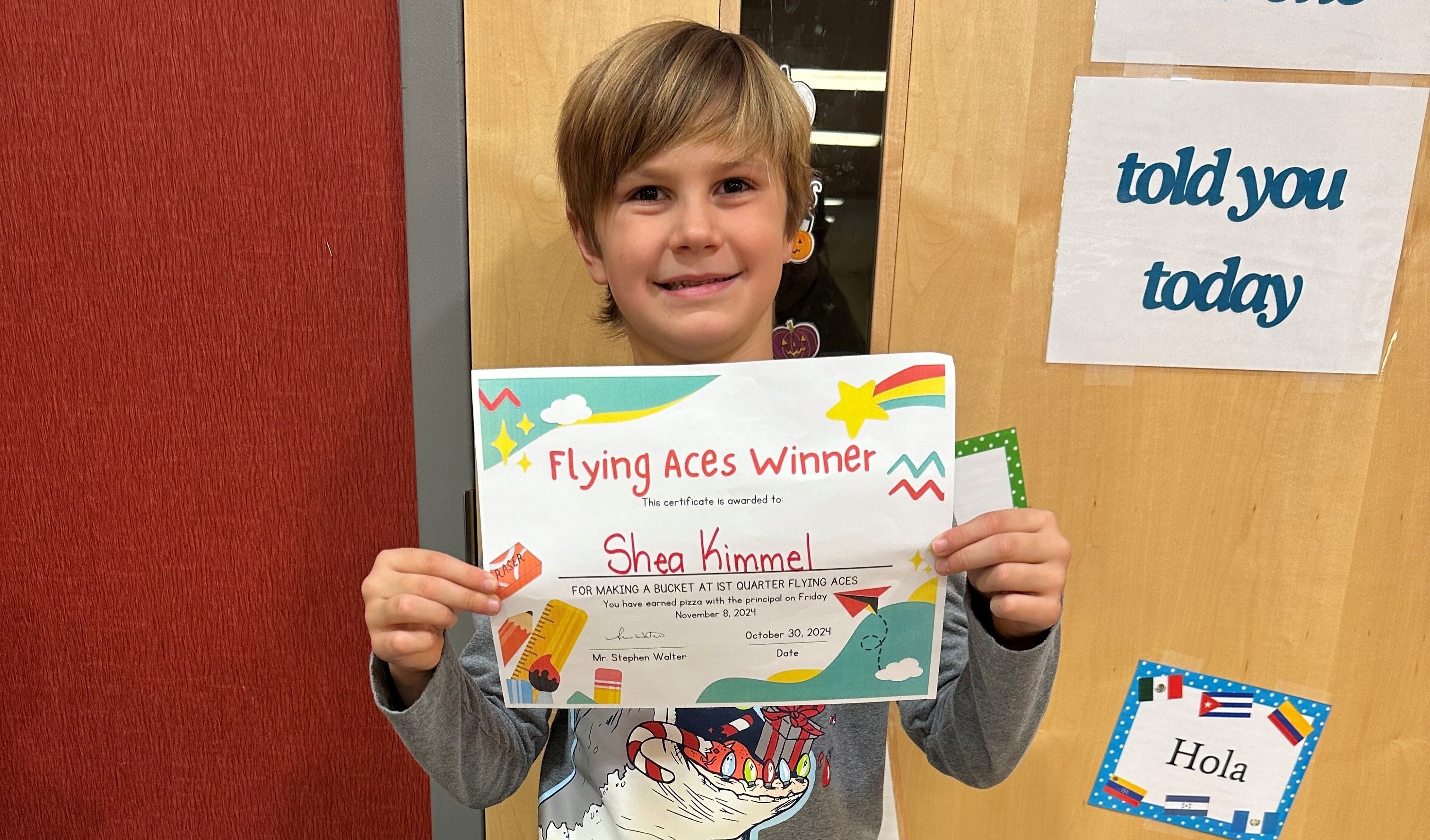 2nd grader showing off his Flying Aces certificate