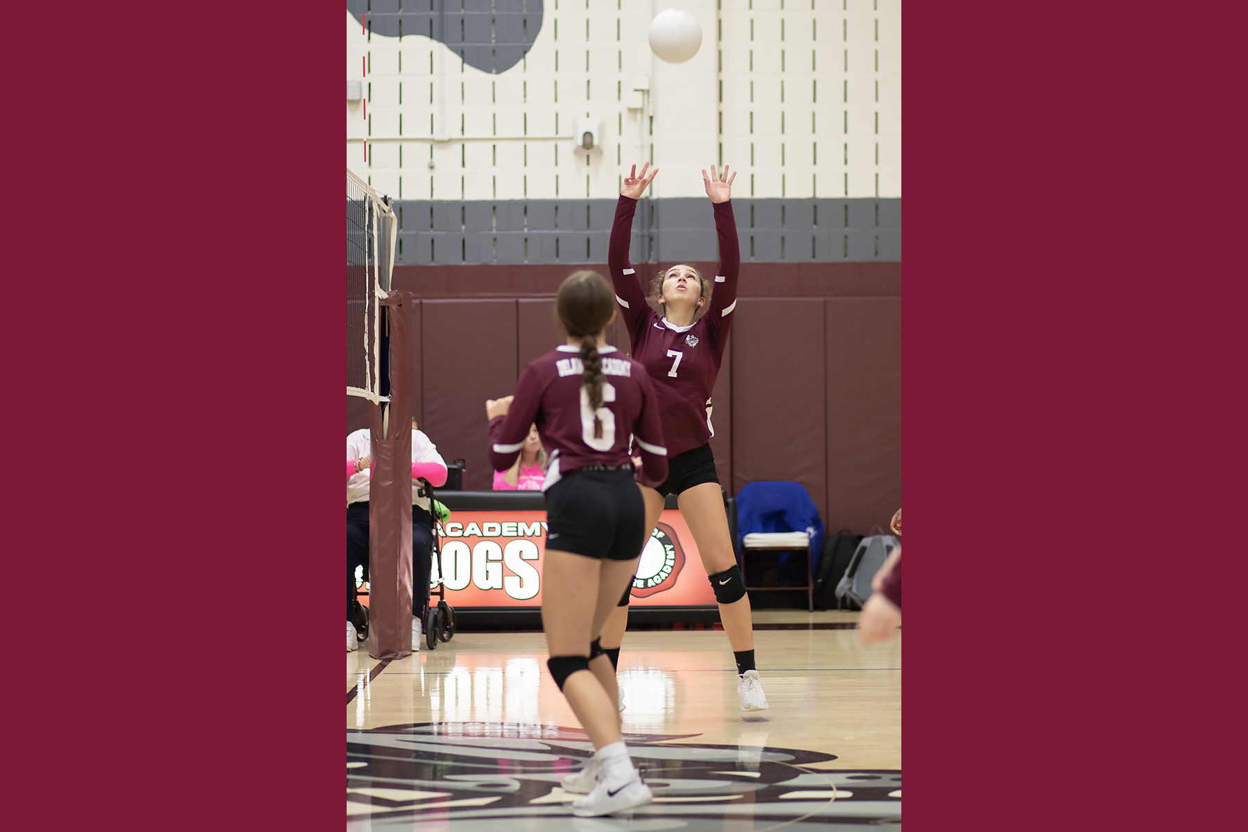 girls playing varsity volleyball