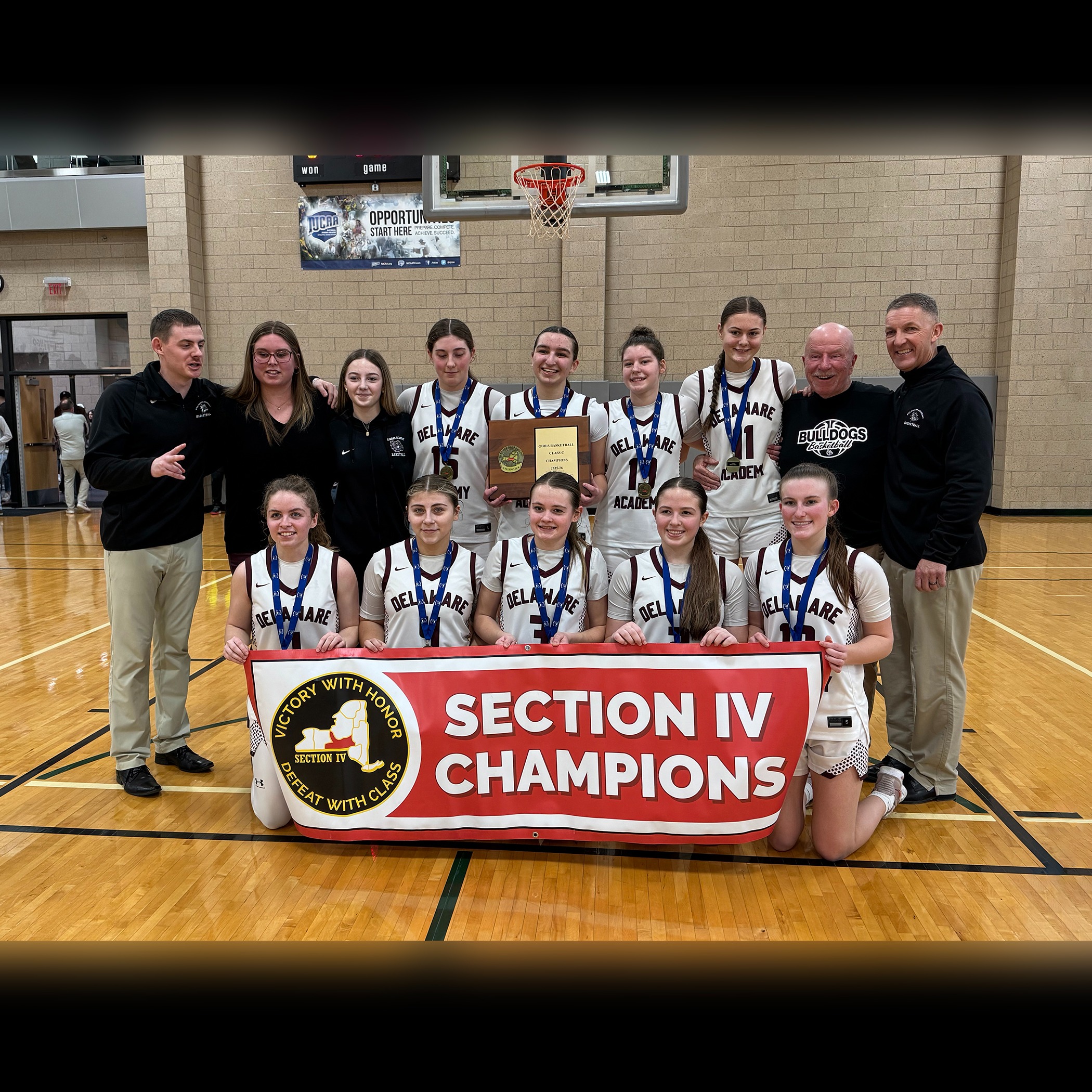 Section IV Champions banner, girls team and coaches