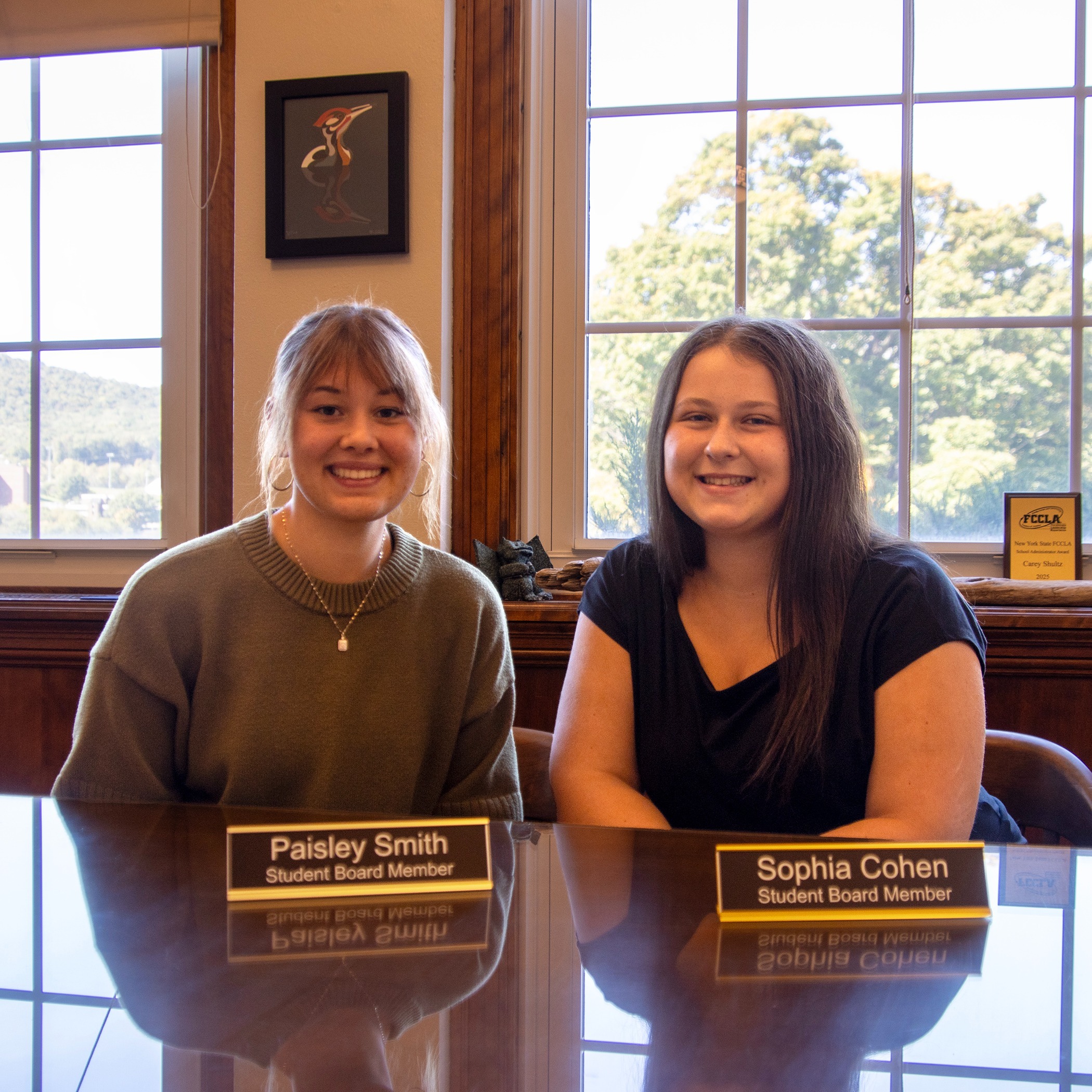 two smiling students with nameplates: Paisley Smith, Student Board Member, Sophia Cohen, Student Board Member
