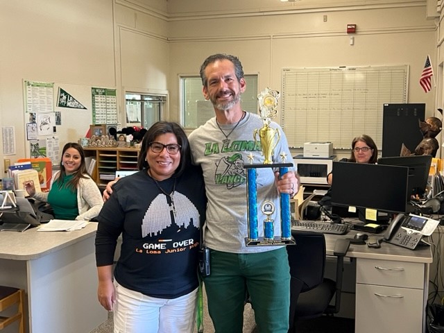 La Loma Principal and staff member in office with Trophy