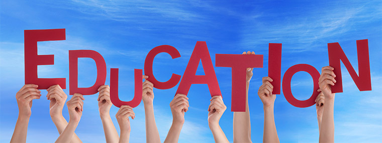 Hands holding letters up to spell "Education"