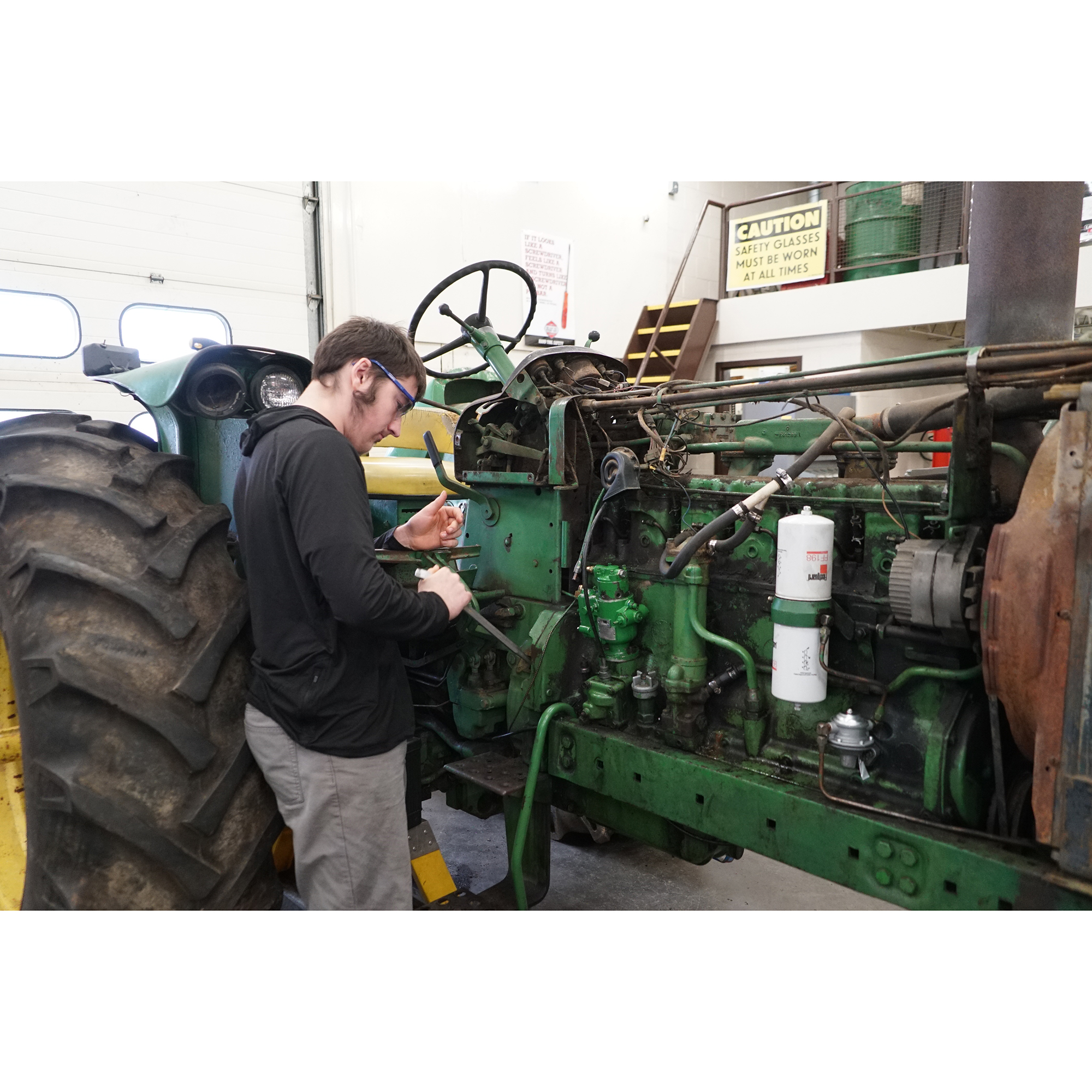 student working on tractor 