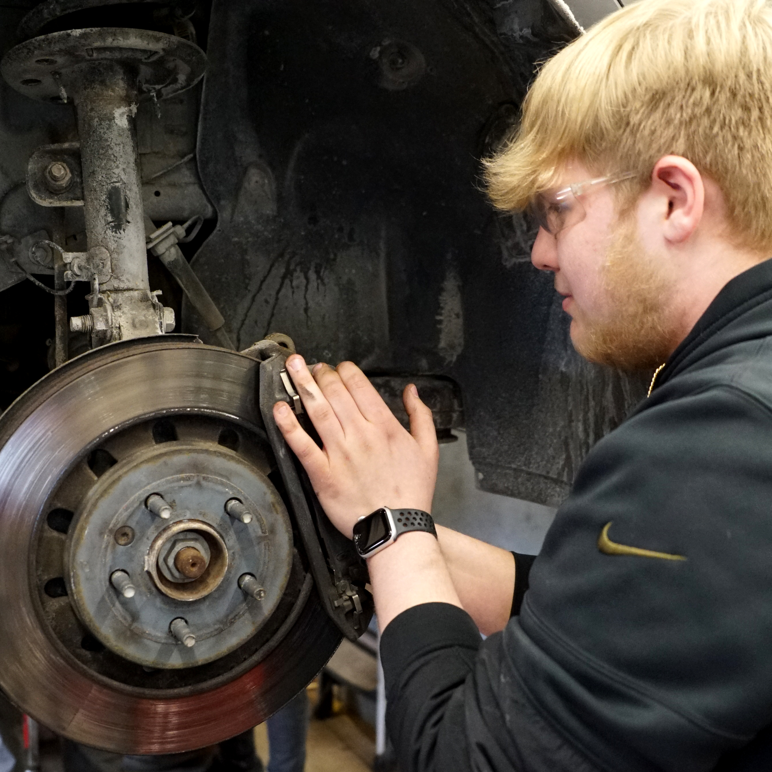 Student working on a car rim