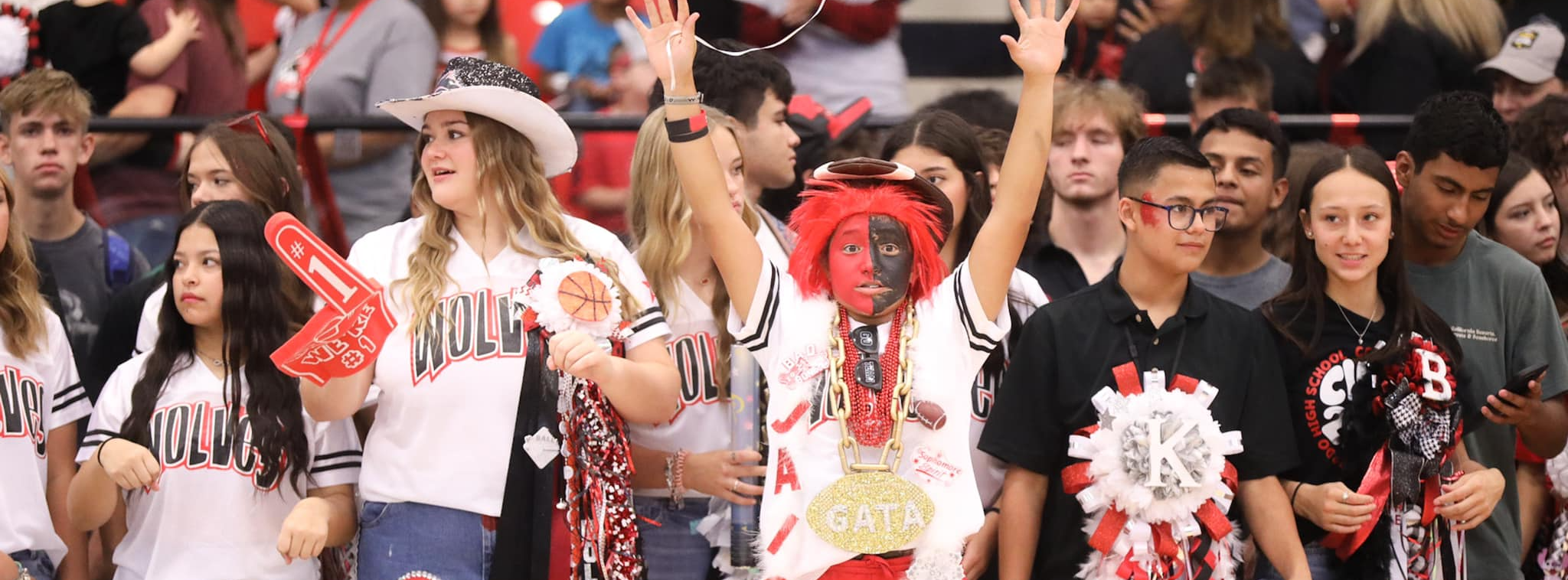 Students cheer on the wolves from the stands. 