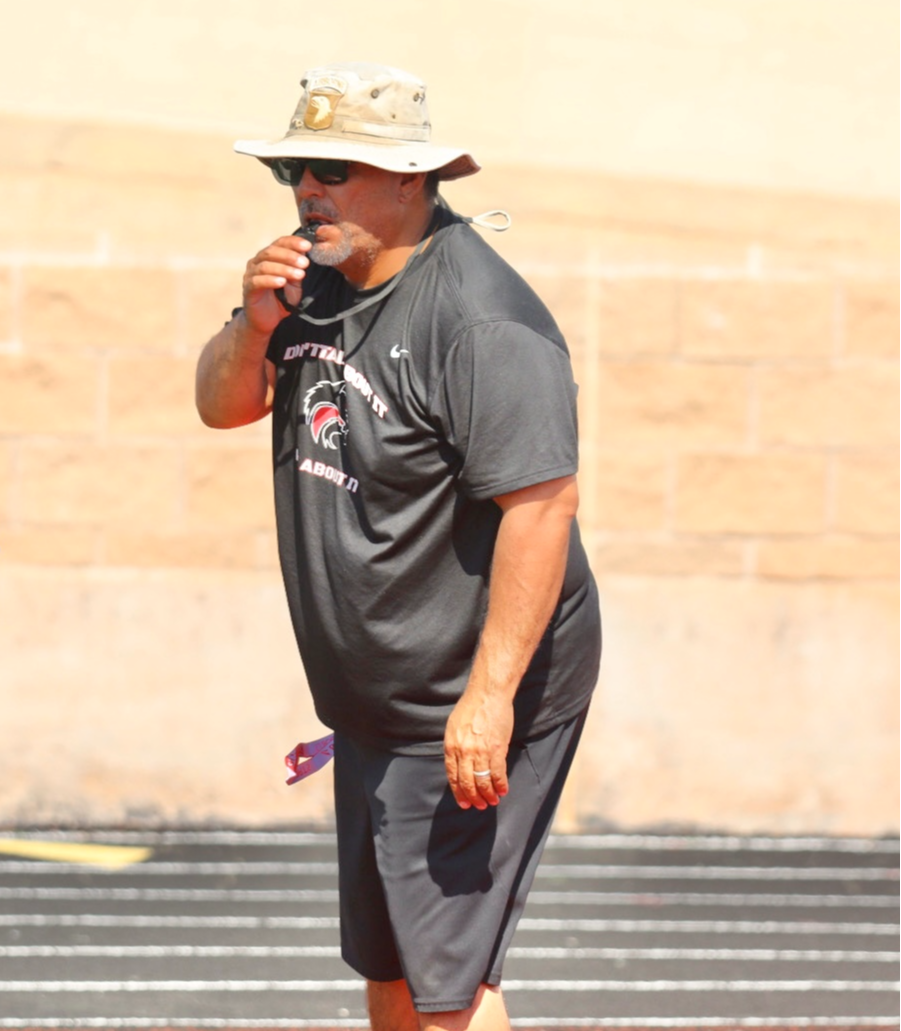 Coach Casarez blowing a whistle in practice