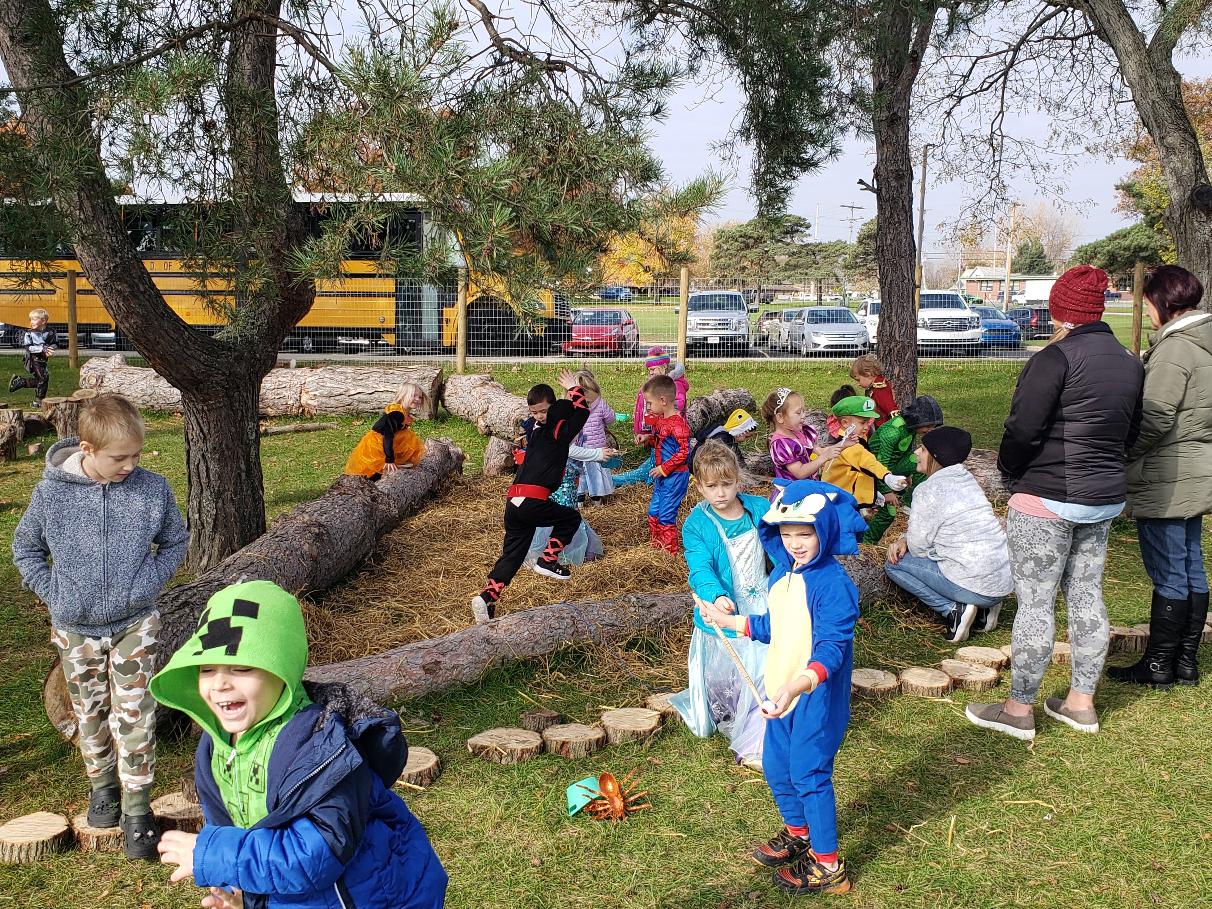 Students in Halloween costumes play outside